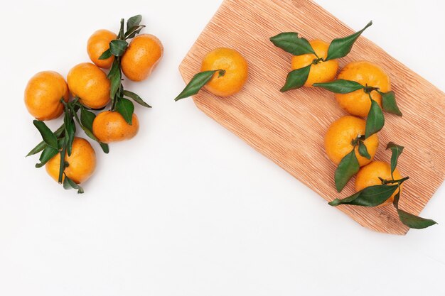 Mandarin oranges with leaves on white 