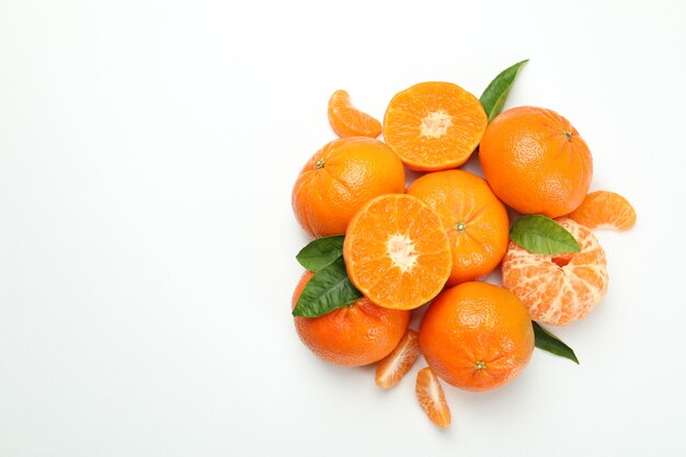 Mandarin pile with leaves on white background