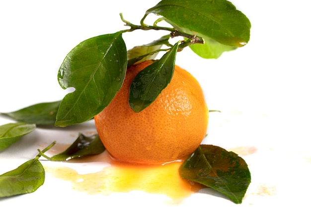 Mandarin with juice and leaves on a white background Beautiful fruit