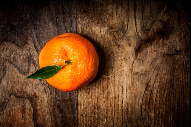 mandarin with leaf on wood