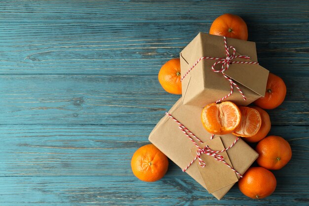 Mandarins and gift boxes on wooden table