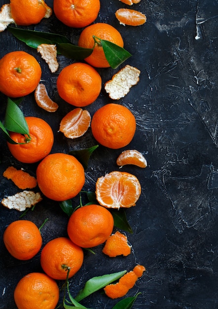 Mandarins with leaves on a dark background