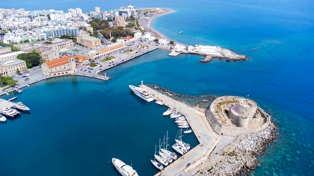 Photo mandraki port of rhodes city harbor and elli beach a popular summer tourist destination aerial panoramic view in rhodes island in greece