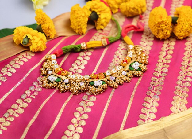 Photo mangalsutra or golden necklace to wear by a married hindu women arranged with beautiful backgrond indian traditional jewellery