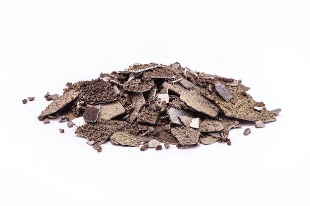 Manganese samples, flaked pure manganese metal used in industry, isolated white background.