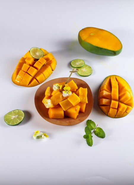 Mangga or Mango ripe with nicely cut pieces on a basket garnish wit viola lime and mint leaf