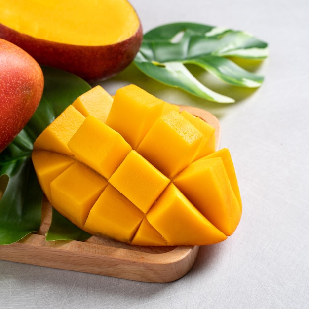 Mango background design concept Top view Diced fresh mango fruit on white table