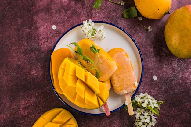 Mango banana popsicles with fresh fruits flat lay top view