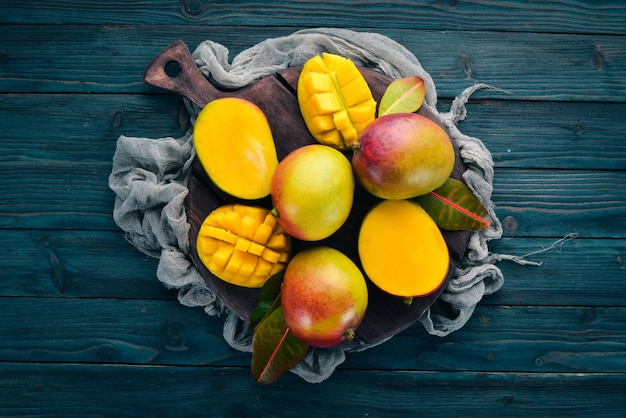 Mango On a blue wooden background Top view Free copy space