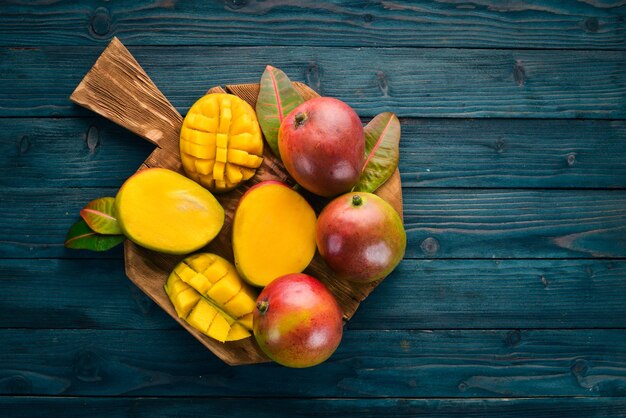 Mango On a blue wooden background Top view Free copy space