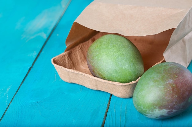 Mango on a cyan wooden surface