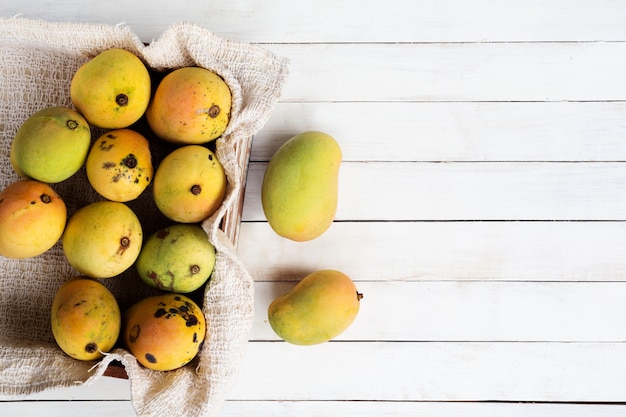 Mango fruit on wood desk with copy space.