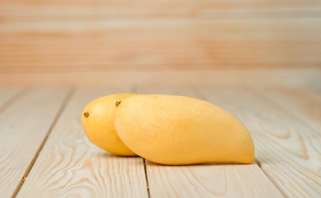 Mango fruit on the wooden table Tropical fruit concept