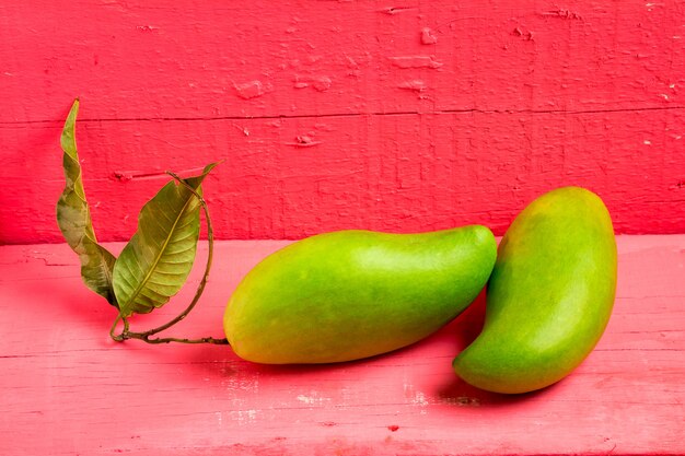 Mango green on wood color pink