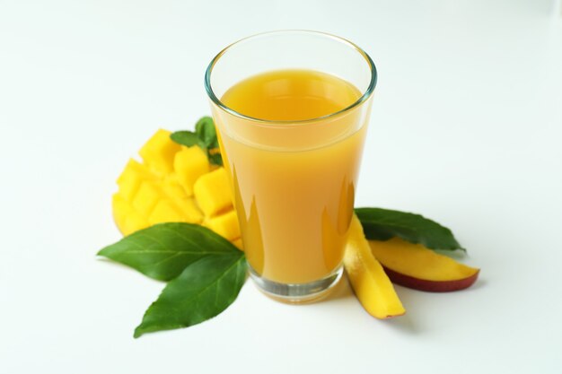 Mango juice and fruit on white