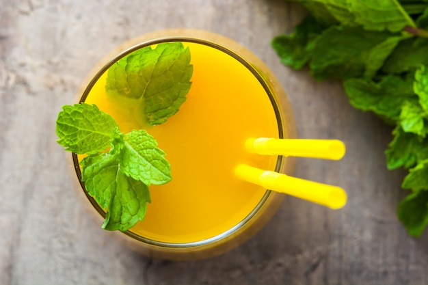 Mango Lassi dessert Traditional Indian drink on wooden table