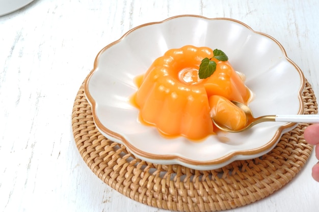 Mango pudding, jelly, dessert on white plate.on white background