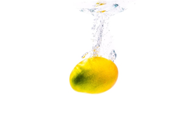 Mango sinking in water isolated on white