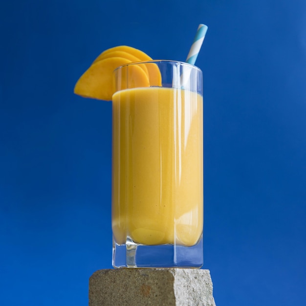 Mango smoothie on a blue background