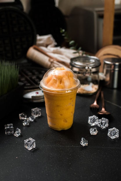 Mango smoothie served on black table at cafeÃ¢ÂÂ