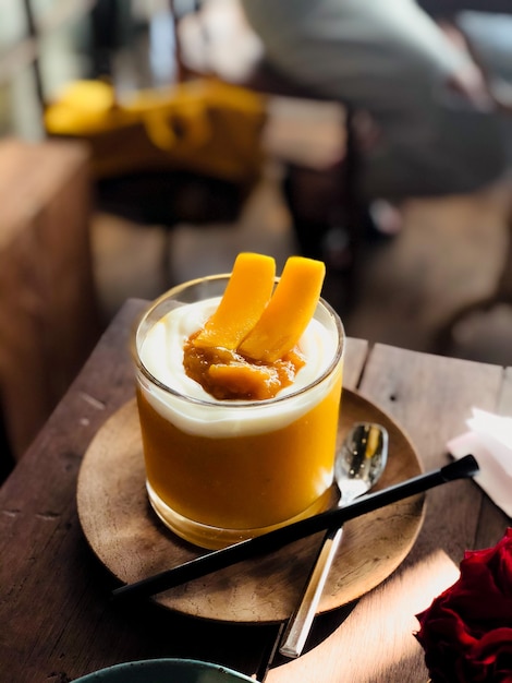 Mango smoothie with beautiful glass in modern cafe.