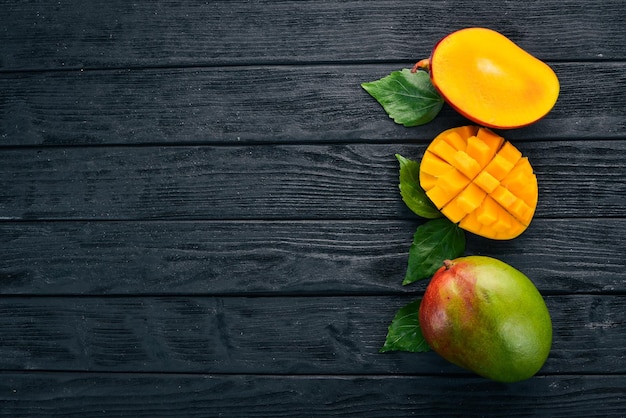 Photo mango tropical fruits on a wooden background top view copy space