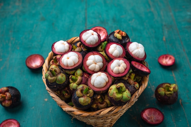 Mangosteen fruit on light blue wooden background,Tropical fruit