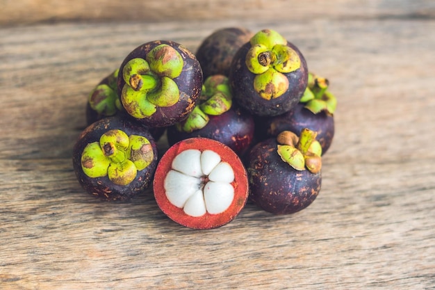 古い木製のテーブルの上のマンゴスチンの果実。トロピカルフルーツ。