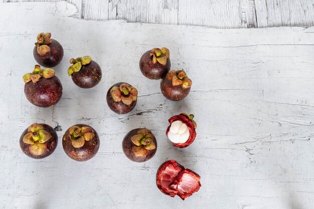 Mangosteen fruit on white wooden background