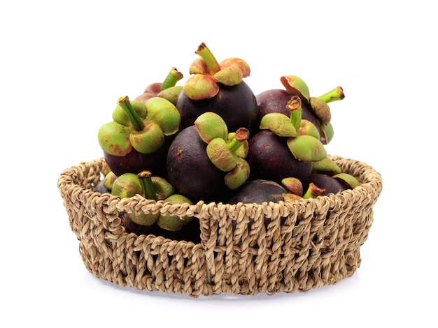 mangosteen fruits in basket isolated on white background