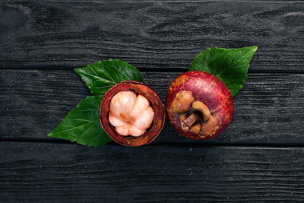 Mangosteen Tropical Fruits On a wooden background Top view Copy space