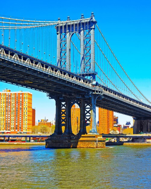 Manhattan bridge across East River, New York, USA. It is among the oldest in the United States of America. NYC, US. Skyline and cityscape. American construction