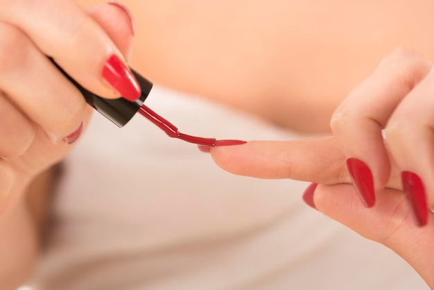 Manicure - beautiful manicured woman's nails with red nail polish.