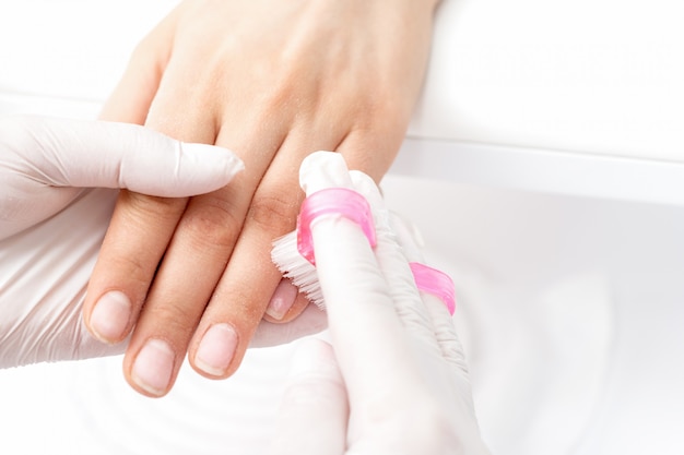 Manicure master removes dust.