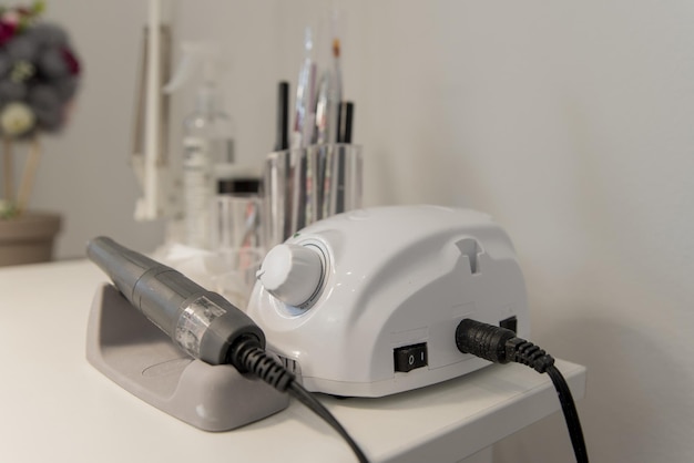 Manicure parlour workplace for a manicurist The manicure machine is on the table