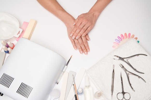 manicure and pedicure items - nail polish drying lamp, nail file, scissors and brushes  