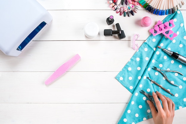 Manicure set and nail polish on wooden background. Top view. Copy space. Still life. Nail Care.