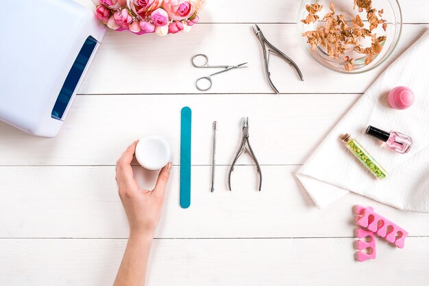 Manicure set and nail polish on wooden background. Top view. Copy space. Still life. Nail Care.