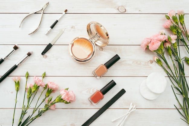 Manicure set and nail polish on wooden background