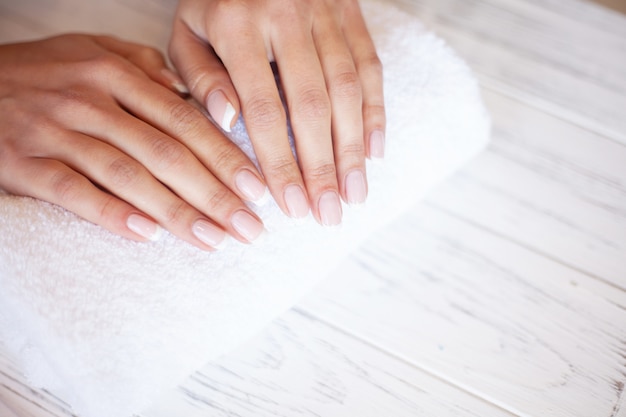 Manicure. Skillful master of manicure holding file in her hands while working in her beauty salon