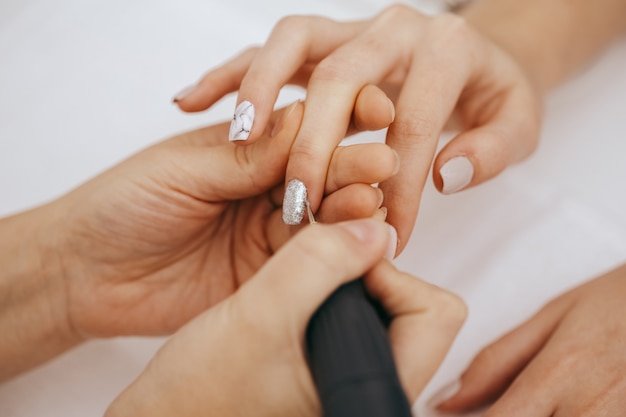 Manicurist with a milling cutter for manicure