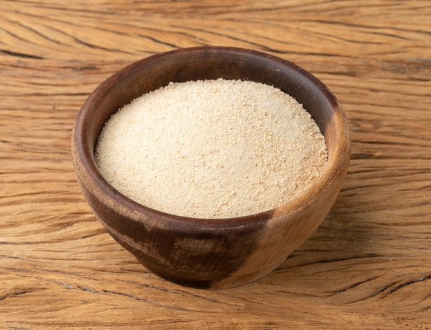 Manioc flour in a bowl over wooden table