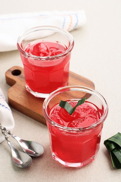 Manisan KolangKaling Preserved Sugar Palm Fruit  Red Color Served in a Glass with Wooden Coaster