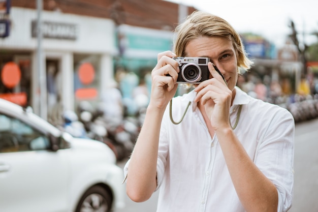 Mannelijke fotograaf met behulp van een vintage camera