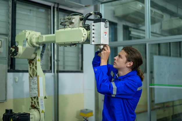 Mannelijke robotica-ingenieur die werkt met het programmeren en manipuleren van robots Hand Industriële robotica