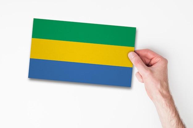 Mannenhand met vlag van Gabon