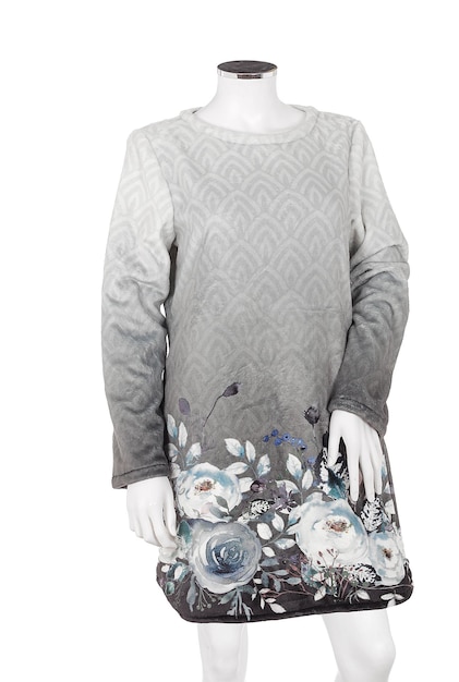 A mannequin wearing a grey dress with flowers on it.