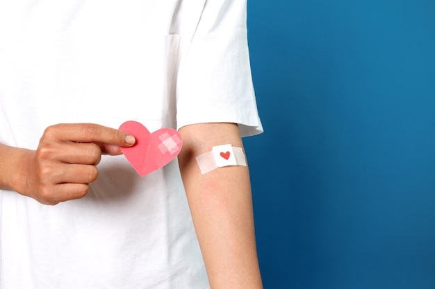 mans arm with the bandage plaster showing as a blood donation volunteer