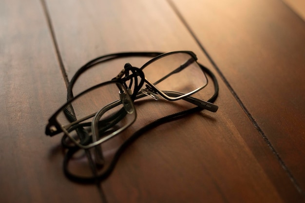 Mans glasses on old wooden table