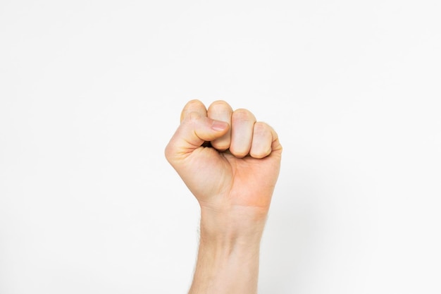 a mans hand holding a fist up in support and protest